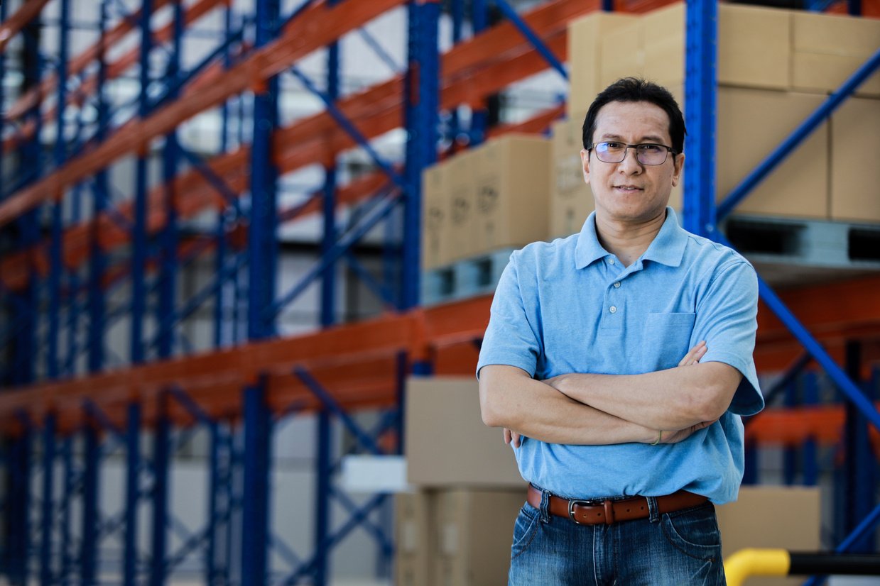 Asian man owner mananger of SME business warehouse storage